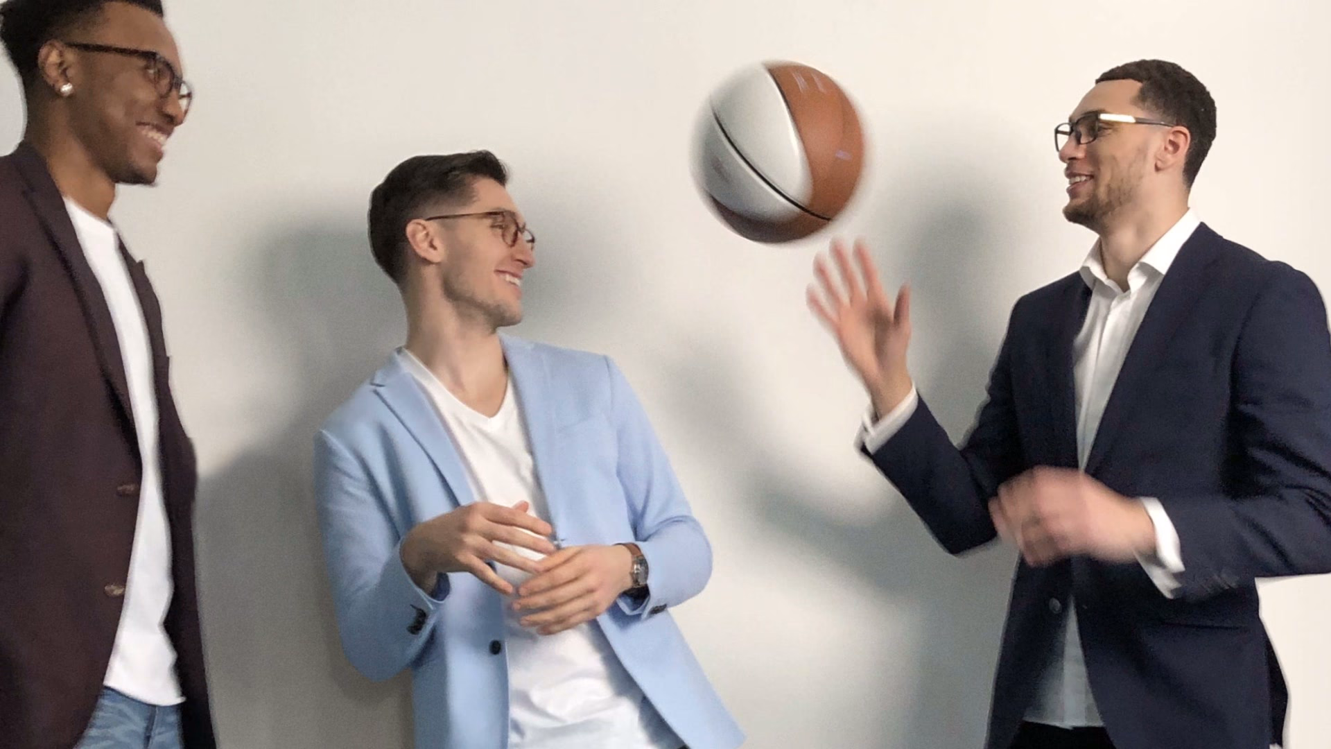 Three models in Zenni frames with a basketball in mid-air